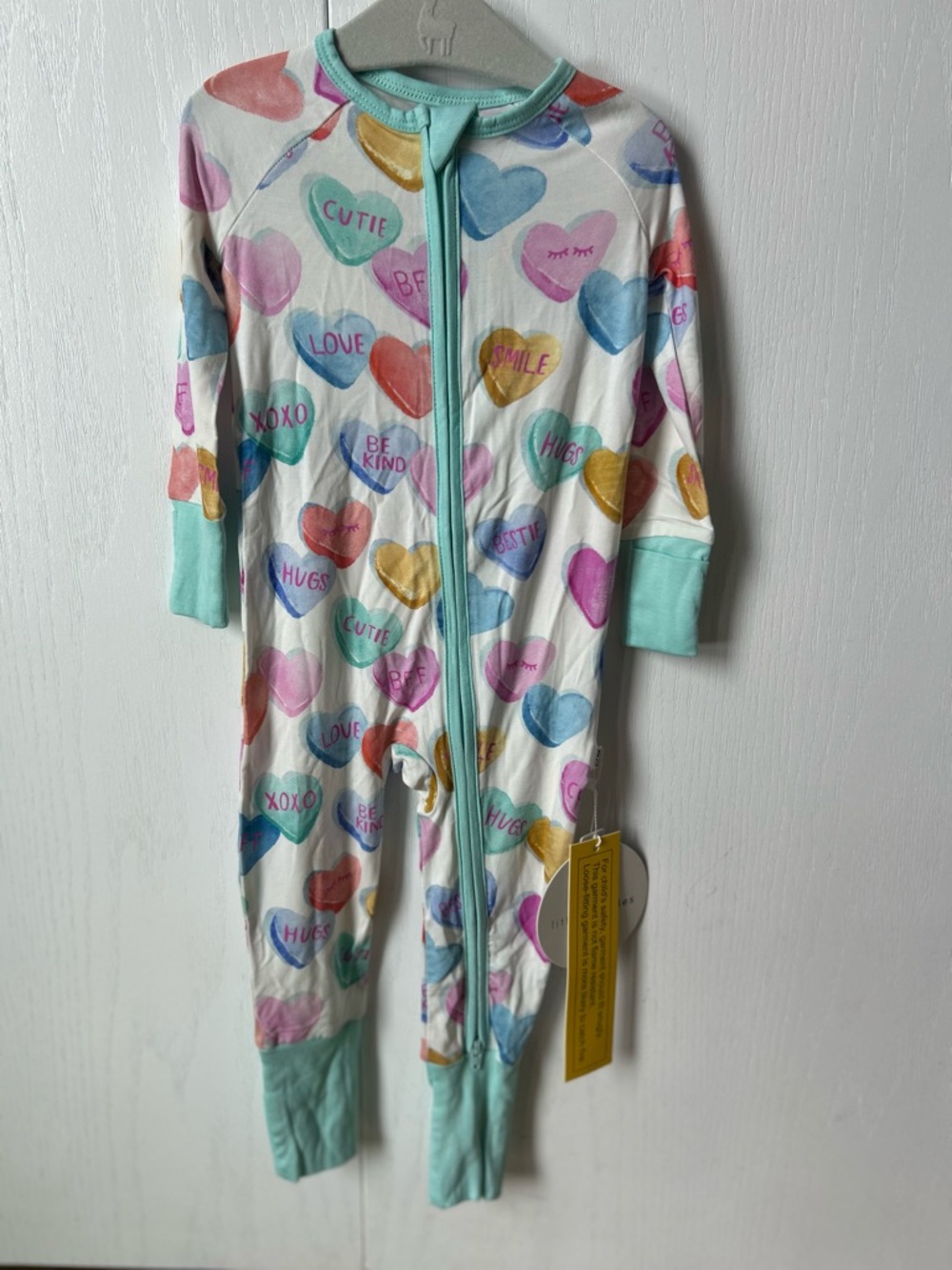 Little Sleepies zip outfit with colorful candy hearts.